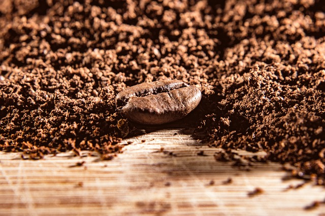 Eine Kaffeebohne vor viel Kaffeepulver